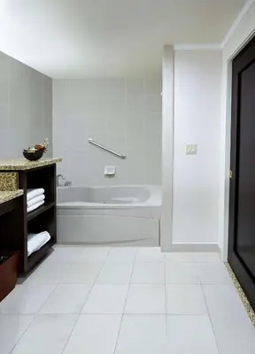 a white bathroom with a tub and a sink at DoubleTree by Hilton Claremont in Claremont