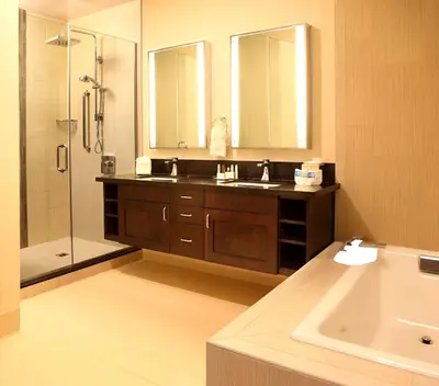 a bathroom with a sink and a shower and a tub at DoubleTree by Hilton Claremont in Claremont