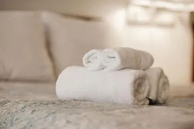 a pile of towels sitting on top of a bed at Vintage Lakeside Inn in Big Bear Lake