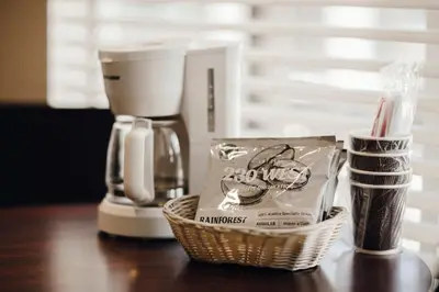 a counter with a coffee maker and a basket of items at Vintage Lakeside Inn in Big Bear Lake