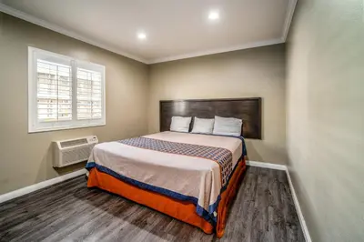 a bedroom with a large bed in a room at Regency Inn & Suites Downey in Downey