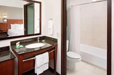 a bathroom with a sink and a toilet and a mirror at Hyatt Place Ontario/Rancho Cucamonga in Ontario