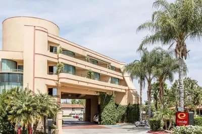 a building with palm trees in front of it at Econo Lodge Inn & Suites Riverside - Corona in Riverside