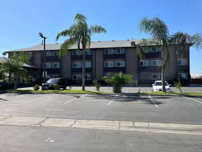 an empty parking lot in front of a building at Studio 6 Suites Delano, CA in Delano
