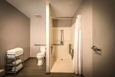 a bathroom with a toilet and a shower at Best Western Plus Media Center Inn & Suites in Burbank