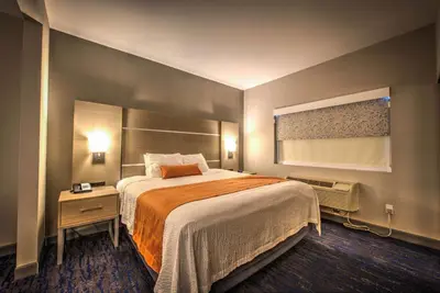 a hotel room with a large bed and a window at Best Western Plus Media Center Inn & Suites in Burbank