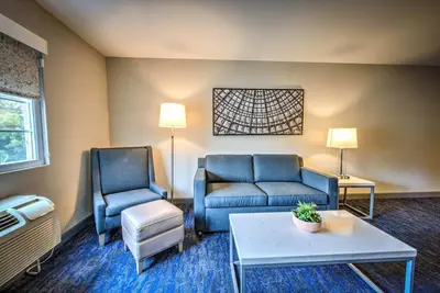 a living room with two chairs and a couch and a table at Best Western Plus Media Center Inn & Suites in Burbank