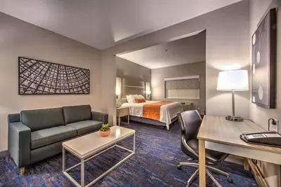 a hotel room with a bed and a couch and a desk at Best Western Plus Media Center Inn & Suites in Burbank