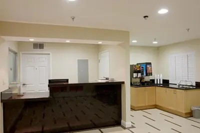 a large room with a kitchen with a counter top at Burbank Inn and Suites in Burbank