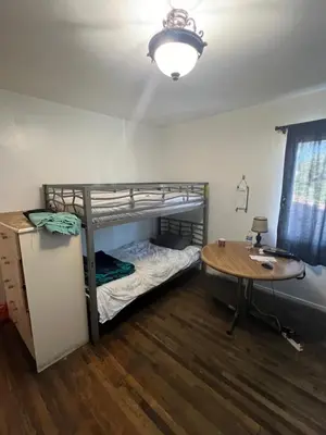 a room with a bunk bed and a table at Timen House in North Hollywood