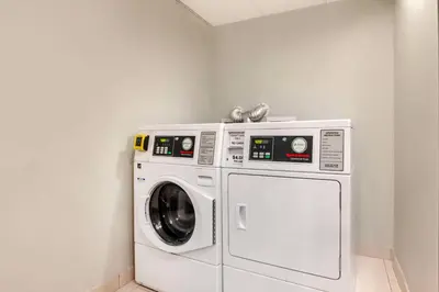 a white washer and dryer in a room at Best Western Plus Commerce Hotel in Los Angeles