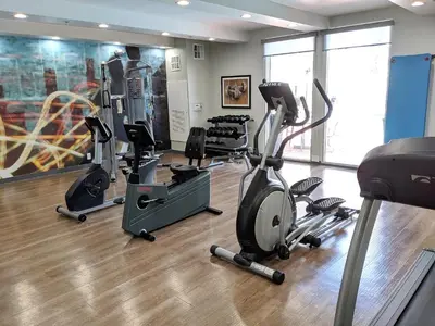 a gym with treadmills and elliptical machines at Best Western Plus Commerce Hotel in Los Angeles