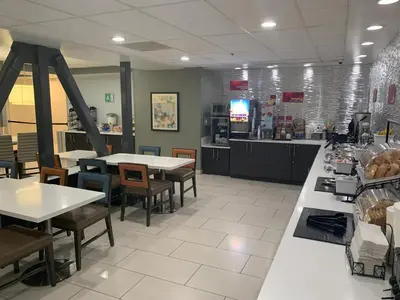 a restaurant with tables and chairs and a counter at Best Western Plus Commerce Hotel in Los Angeles