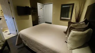 a bedroom with a bed with two pillows at Trylon Hotel - Hollywood in Los Angeles