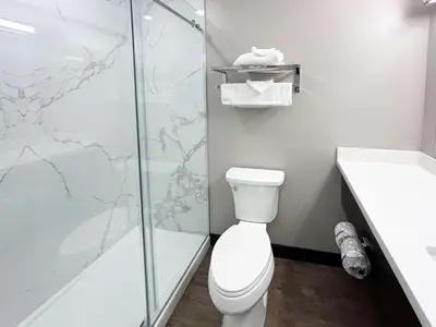 a bathroom with a toilet and a glass shower at Studio 6 Corona, CA West in Corona