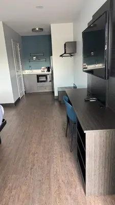 a room with a kitchen with a counter and a table at Studio 6 Corona, CA West in Corona
