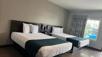 a hotel room with two beds and a window at Studio 6 Corona, CA West in Corona