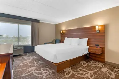 a hotel room with a large bed and a window at Comfort Inn Anaheim Resort in Anaheim