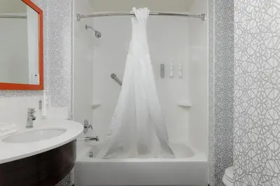 a white bathroom with a shower and a sink at Hampton Inn & Suites Palmdale in Palmdale