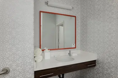 a bathroom with a sink and a mirror at Hampton Inn & Suites Palmdale in Palmdale