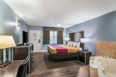 a hotel room with a bed and a bathroom at Econo Lodge Hesperia - Victorville I-15 in Hesperia