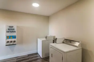 a laundry room with a washer and dryer in it at Econo Lodge Hesperia - Victorville I-15 in Hesperia