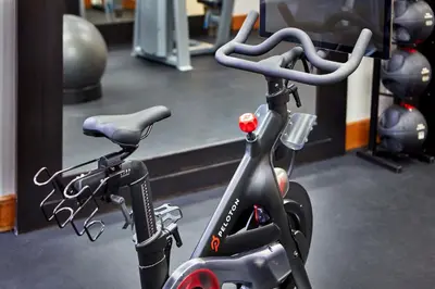 an exercise bike in a gym with a mirror at Hilton Garden Inn Valencia Six Flags in Valencia