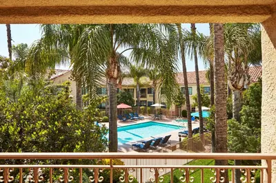 a view from the balcony of a resort with a swimming pool at Hilton Garden Inn Valencia Six Flags in Valencia