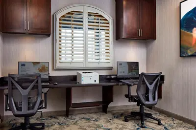 an office with a desk with two computers and two chairs at Hilton Garden Inn Valencia Six Flags in Valencia