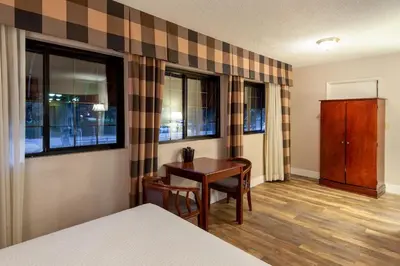 a room with a table and a table and chairs at Studio City Court Yard Hotel in Los Angeles