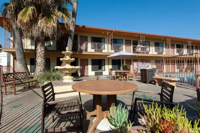 a patio with a table and chairs and a fountain at Studio City Court Yard Hotel in Los Angeles