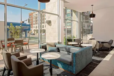 a lobby with a couch and tables and windows at Hyatt Place Glendale/Los Angeles in Glendale
