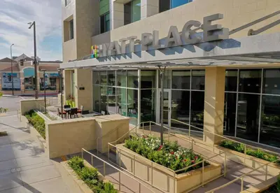 an office building with plants in front of it at Hyatt Place Glendale/Los Angeles in Glendale