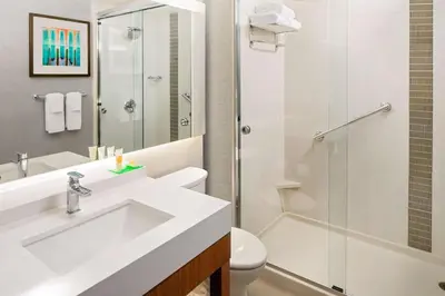 a bathroom with a sink and a toilet and a shower at Hyatt Place Glendale/Los Angeles in Glendale
