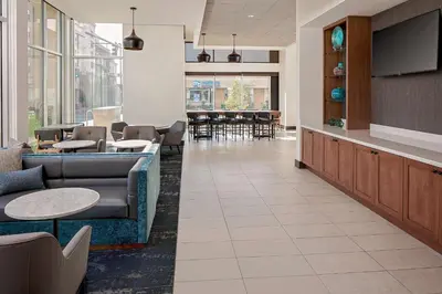 a waiting room with couches and a flat screen tv at Hyatt Place Glendale/Los Angeles in Glendale
