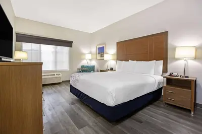 a hotel room with a large bed and a television at La Quinta by Wyndham NE Long Beach/Cypress in Hawaiian Gardens