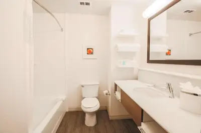 a white bathroom with a toilet and a sink at Hampton Inn & Suites Camarillo in Camarillo