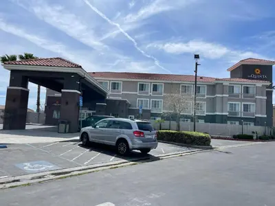 a car parked in a parking lot in front of a hotel at La Quinta by Wyndham Hesperia Victorville in Hesperia