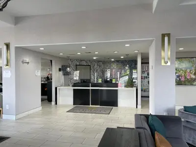 a living room with a couch and a kitchen at La Quinta by Wyndham Hesperia Victorville in Hesperia