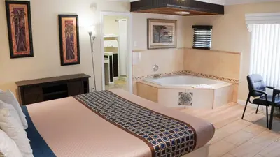a bedroom with a bed and a bath tub at 777 Motor Inn in Sherman Oaks