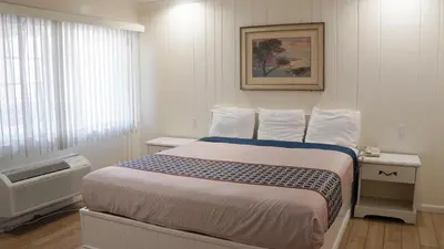 a hotel room with a bed and a window at 777 Motor Inn in Sherman Oaks