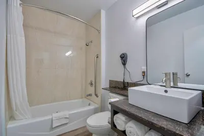 a bathroom with a sink and a tub and a toilet at Studio 6 Suites San Bernardino, CA in San Bernardino
