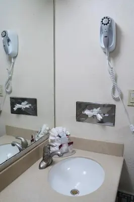 a bathroom with a sink and a mirror at California Inn Barstow in Barstow
