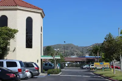 a parking lot with cars parked in front of a church at Ocean Gateway Inn in Santa Paula