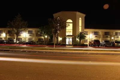 a building with cars parked in front of it at night at Ocean Gateway Inn in Santa Paula