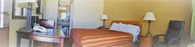 a hotel room with a bed and a telephone at Executive Inn Mojave in Mojave