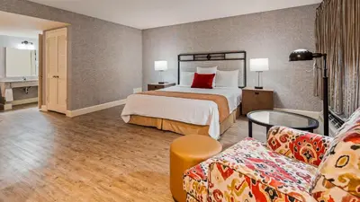 a hotel room with a bed and a couch at SureStay Hotel by Best Western Camarillo in Camarillo