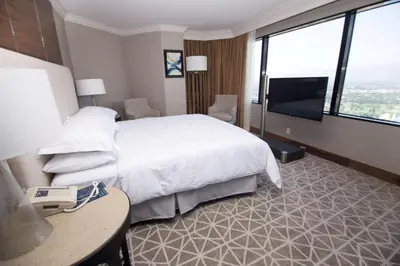 a hotel room with a bed and a television at Hilton Los Angeles-Universal City in Los Angeles