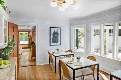a dining room with two tables and chairs and windows at Channel Road Inn, A Four Sisters Inn in Los Angeles