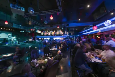 a group of people sitting at tables in a restaurant at Grand Vista Hotel in Simi Valley